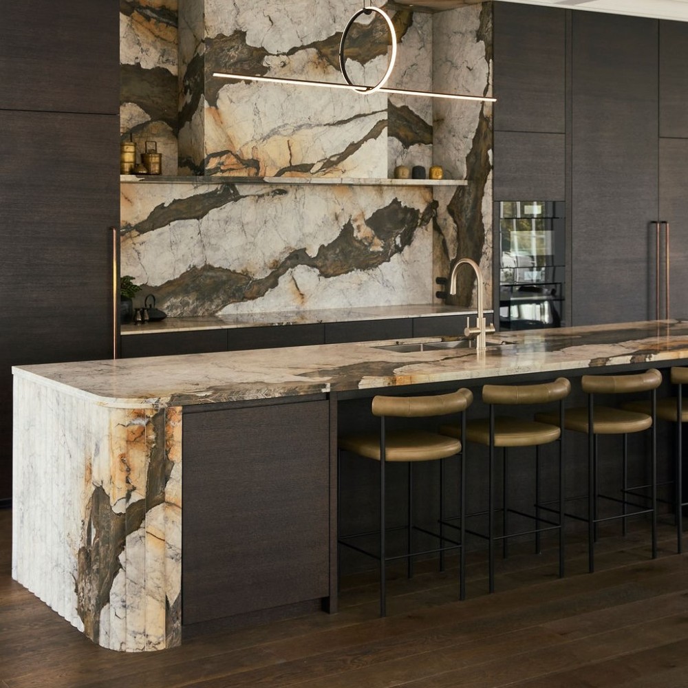 Iron white Calacatta marble kitchen island with multifaceted waterfall end and splashback and cladded rangehood v2